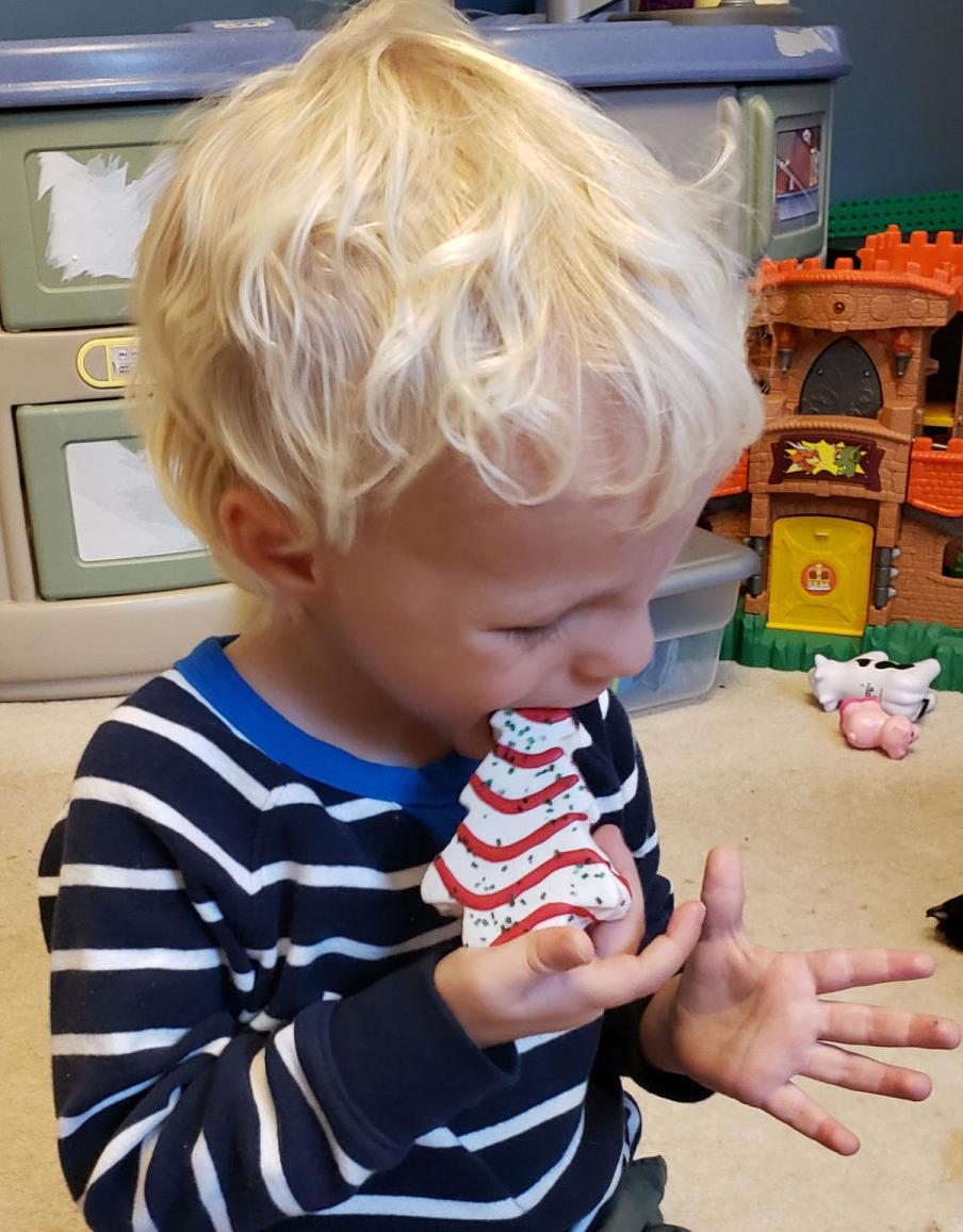 Harrison eating Little Debbie Christmas Tree